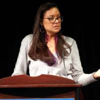 Lin Bardwell, moderator of the event, shares as a story with the group